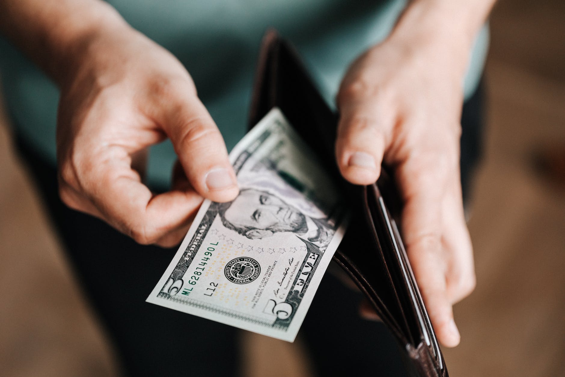How to Create a Budget and Reach Your Financial Goals 3 unrecognizable man holding wallet with money